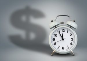 Alarm clock with dollar shadow, time is money concept
