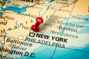 Pushpin pointing at New York City in USA, America