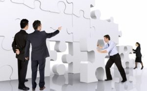 business teamwork - business men making a puzzle